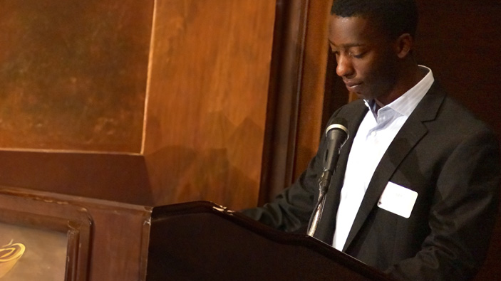 Young man at a funeral giving a talk