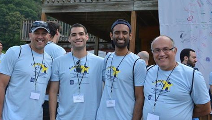 Four men in camp erin t-shirts