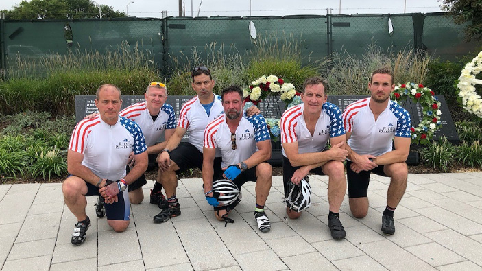 Group of men. Team Jess in cycling outfits