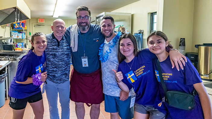 Group of people smiling in a hospital setting