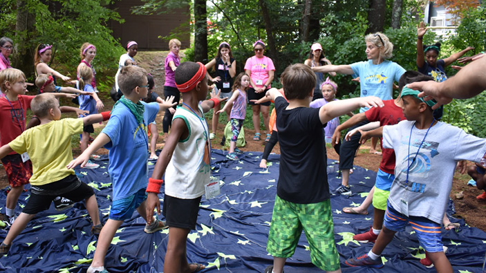 Group of young children doing yoga at camp