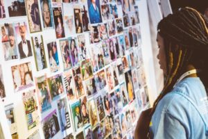 A woman looking at a wall of photos