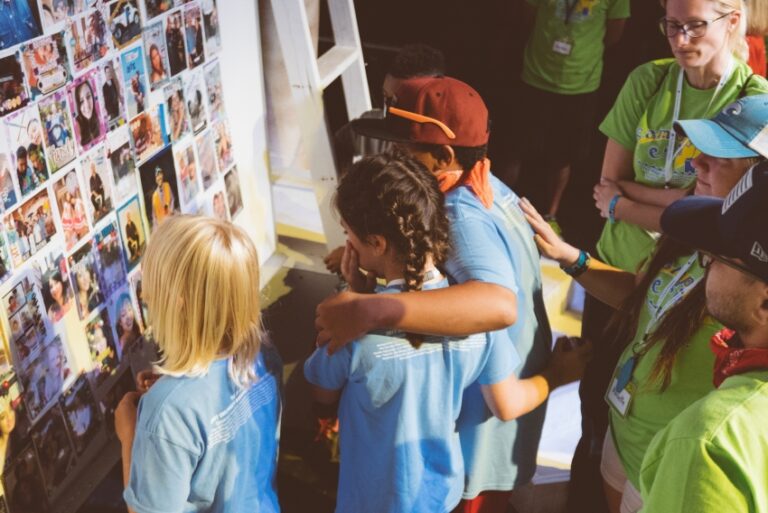 a group of Eluna's Camp Erin campers looking at a family memory board