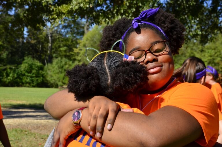 two campers hugging at Camp Erin