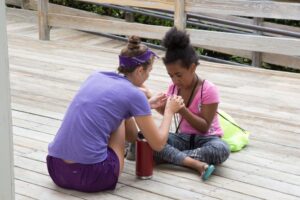 An Eluna camper working on an activity.