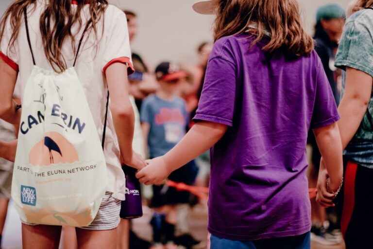 two campers holding hands at Camp Erin