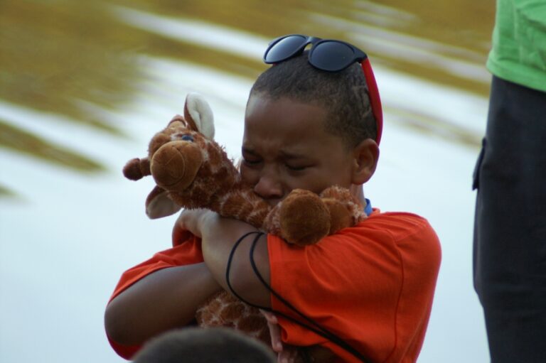 a child hugging their stuffed animal for emotional support