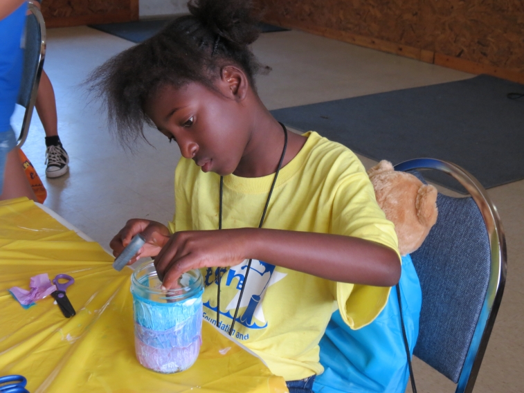 An Eluna Camp Erin Camper working on a Family memory Jar