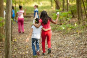 two kids walking on a nature trail