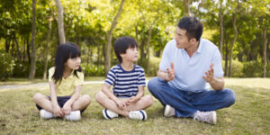 a father sitting and talking with his kids