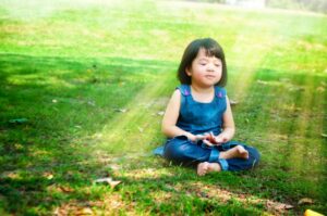 a child sitting in the grass