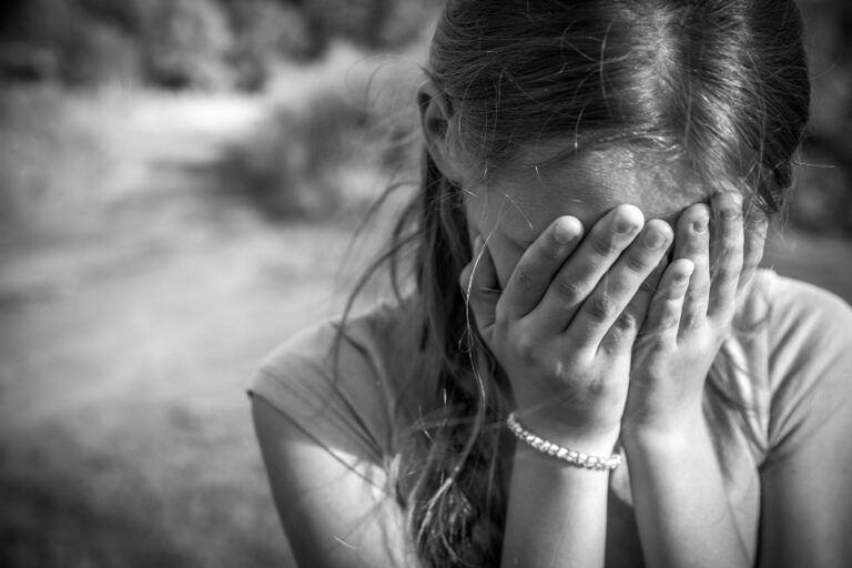 a child with her head in her hands