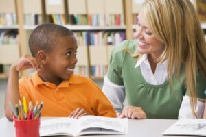 An adult and child discuss a book