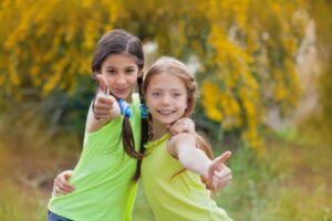 two kids giving thumbs up