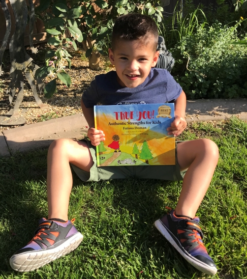 a child holding the True You book