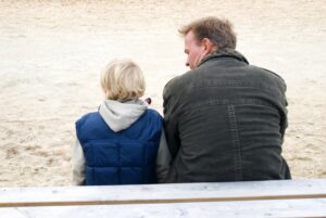 a parent and teens having a conversation with their backs to the camera