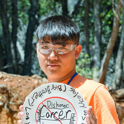 camper holding a memory activity