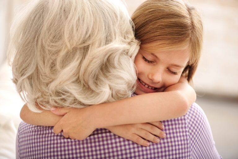 a grandmother hugging her granddaughter.