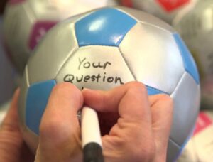 Thumb Ball Activity image. Writing questions onto a mini soccer ball.