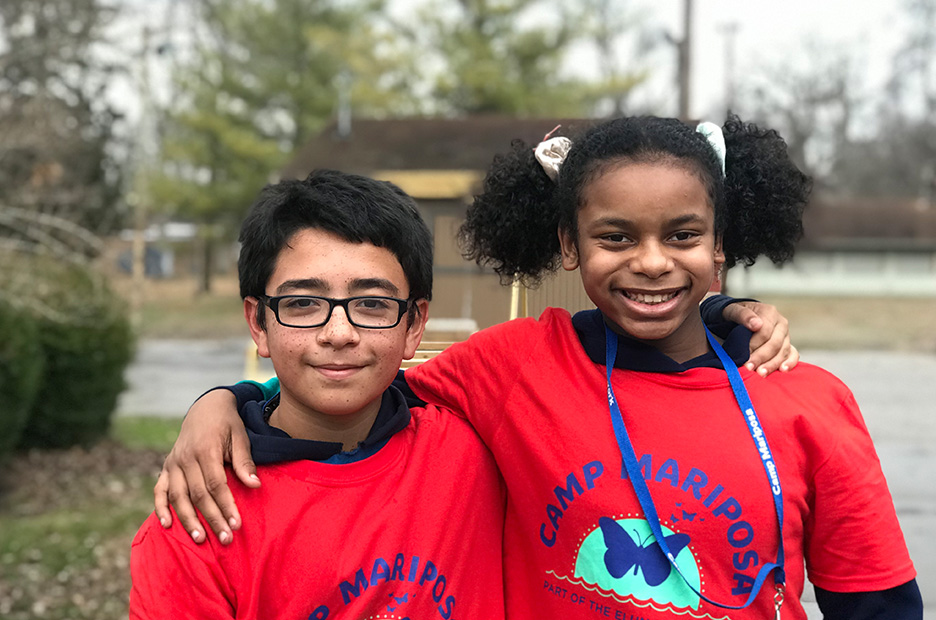 Boy and girl campers smiling at the camera