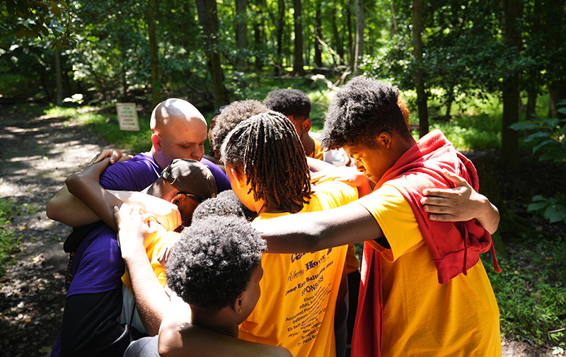 group of kids hugging in a circle