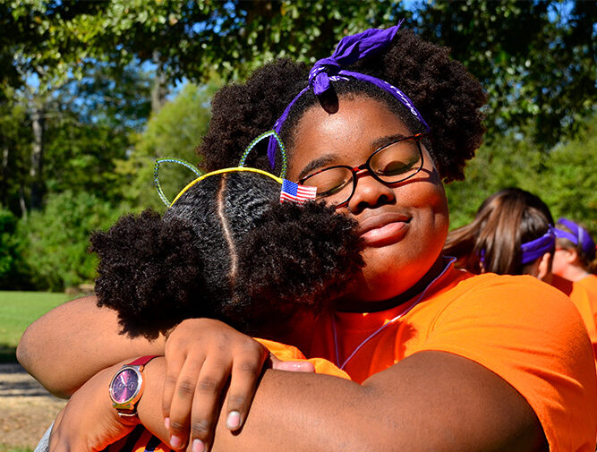 camp erin grief camp campers hugging